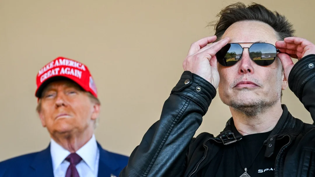 elon musk putting sunglasses on while standing in front of donald trump